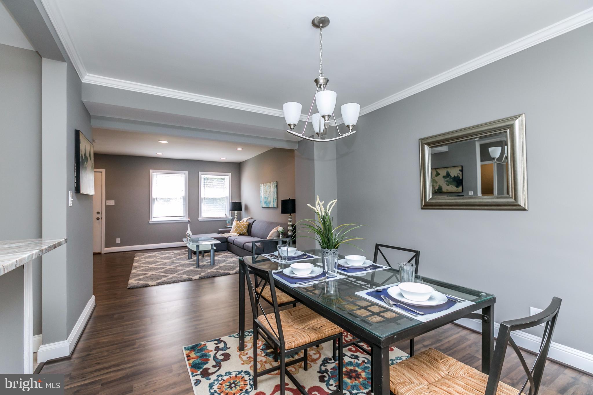 4674 Marble Hall Road Baltimore, MD 21239 - Photo 7 of 29 a view of a dining room with furniture wooden floor and chandelier