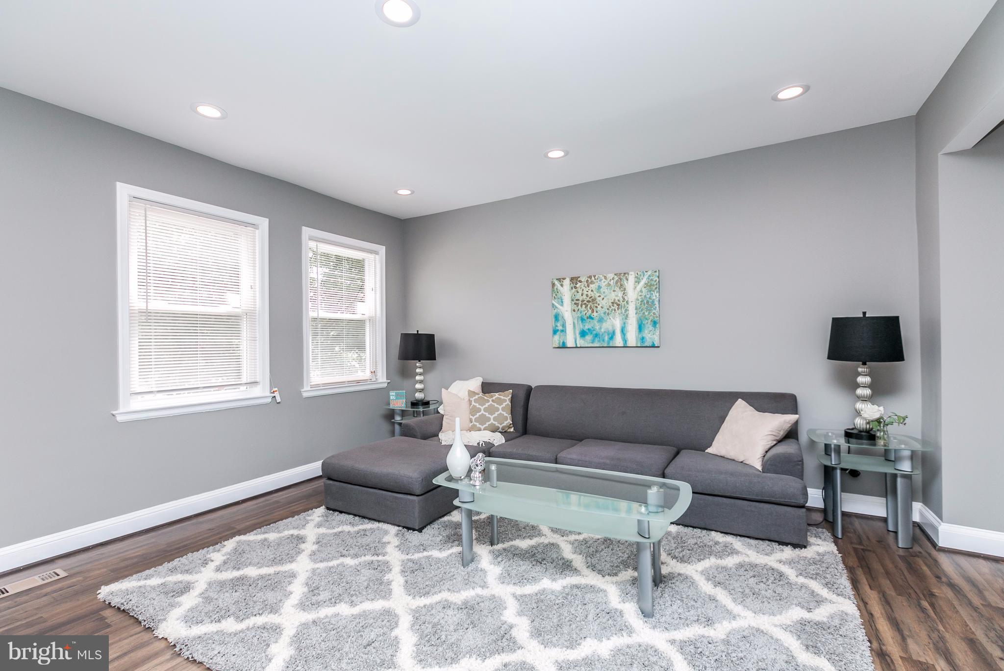 4674 Marble Hall Road Baltimore, MD 21239 - Photo 8 of 29 a living room with furniture and a flat screen tv