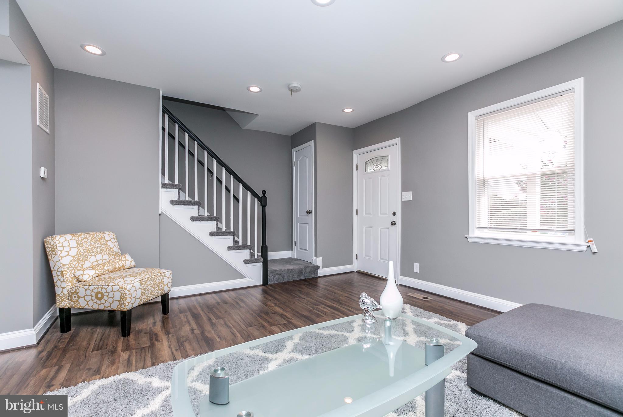 4674 Marble Hall Road Baltimore, MD 21239 - Photo 9 of 29 a living room with furniture and a wooden floor