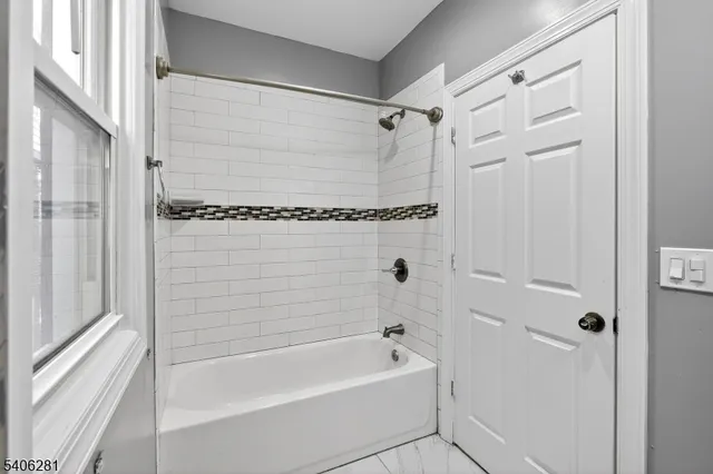 a bathroom with a shower and a bath tub
