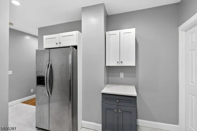 a kitchen with a refrigerator and a sink