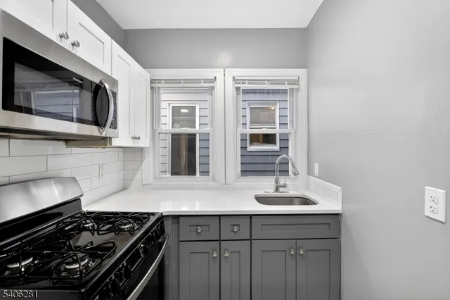 a kitchen with stainless steel appliances a stove and a microwave