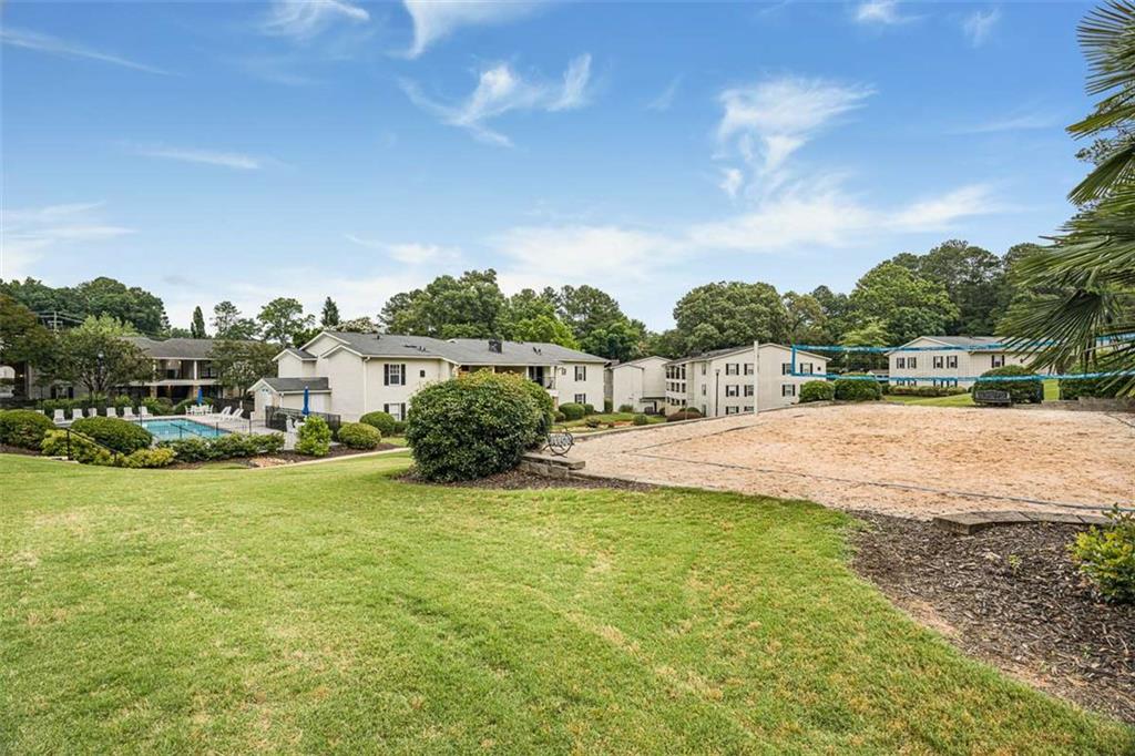 1150 Collier Road Northwest, Unit 25D Atlanta, GA 30318 - Photo 17 of 21 a view of swimming pool with seating area and trees in the background