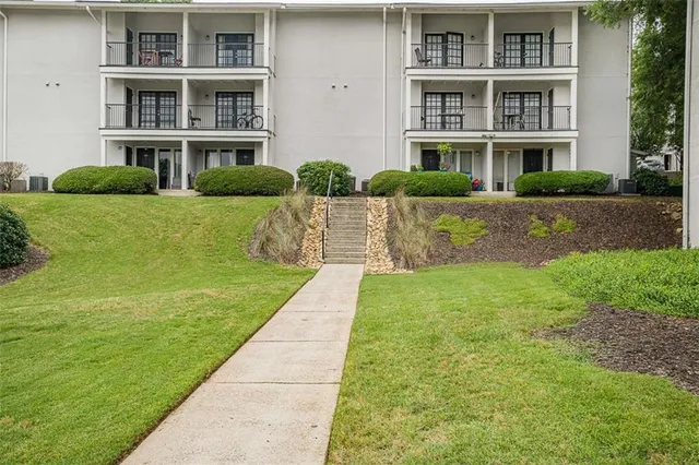 a front view of a building with a garden