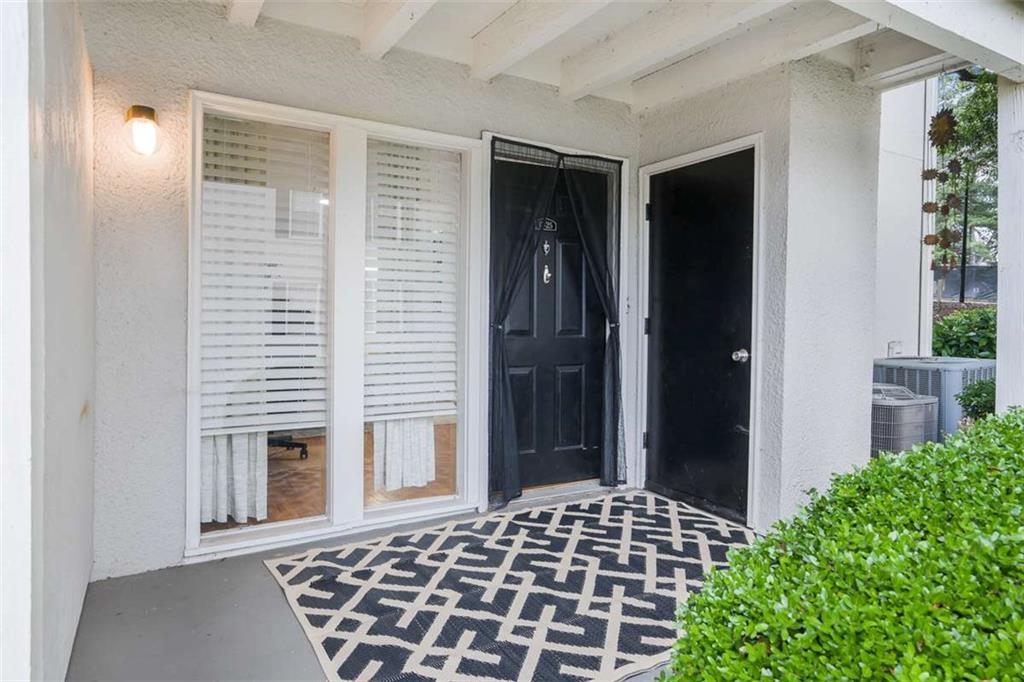 1150 Collier Road Northwest, Unit 25D Atlanta, GA 30318 - Photo 3 of 21 a backyard of a house with potted plants