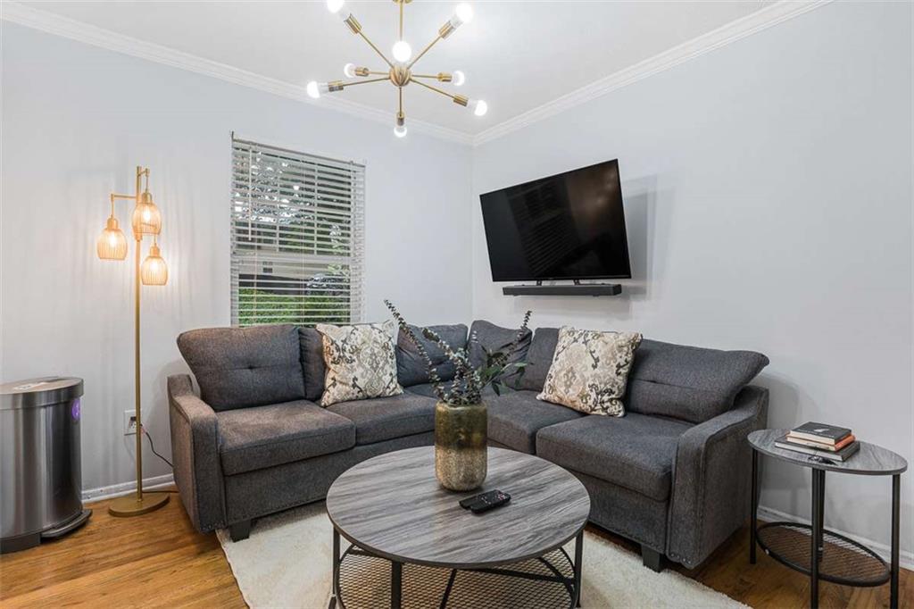 1150 Collier Road Northwest, Unit 25D Atlanta, GA 30318 - Photo 10 of 21 a living room with furniture and a flat screen tv