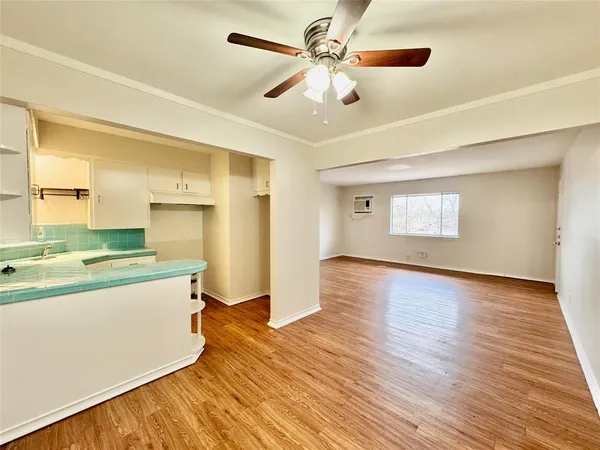 a view of a kitchen with a sink and wooden floor