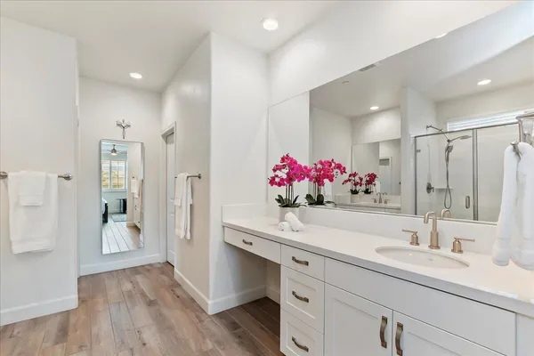 a bathroom with a sink vanity and a mirror