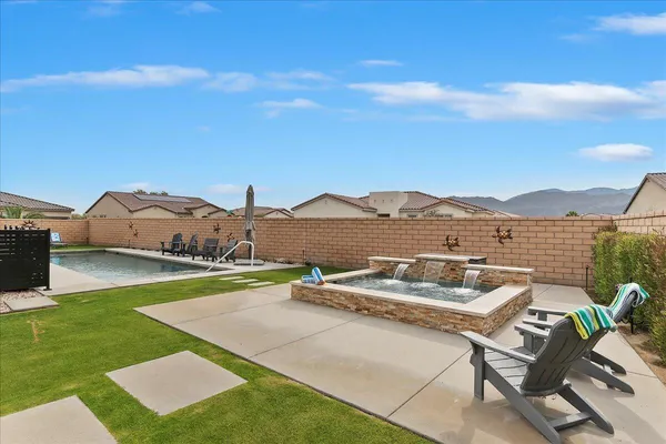 a view of a house with patio and garden