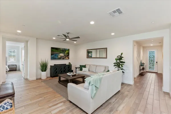 a living room with furniture and wooden floor