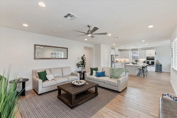 a living room with furniture and wooden floor