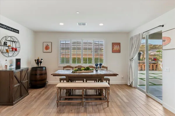 a view of a livingroom with furniture window and wooden floor