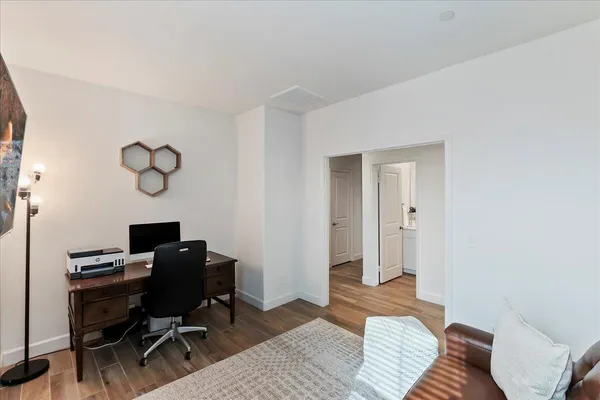 a bedroom with a workspace