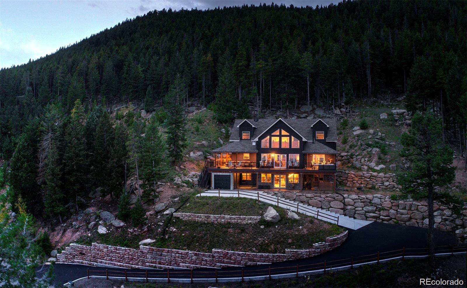 8335 Doubleheader Ranch Road Morrison, CO 80465 - Photo 1 of 1 a front view of a house with a yard