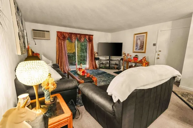 a living room with furniture a flat screen tv and a large window