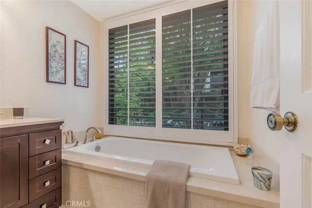 a bathroom with a shower sink vanity granite and mirror
