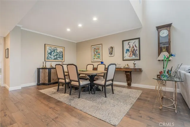 a view of a dining room with furniture and a wooden floor