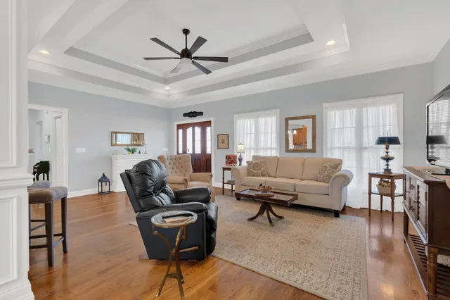 a living room with furniture and a wooden floor