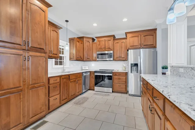 a kitchen with stainless steel appliances granite countertop a refrigerator sink and cabinets