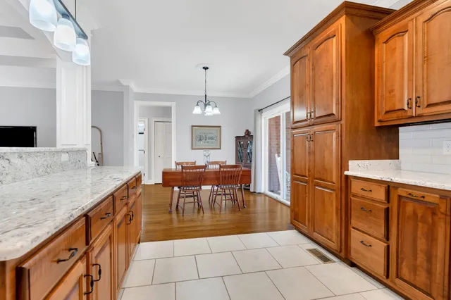 a kitchen with stainless steel appliances granite countertop a refrigerator a sink and a stove