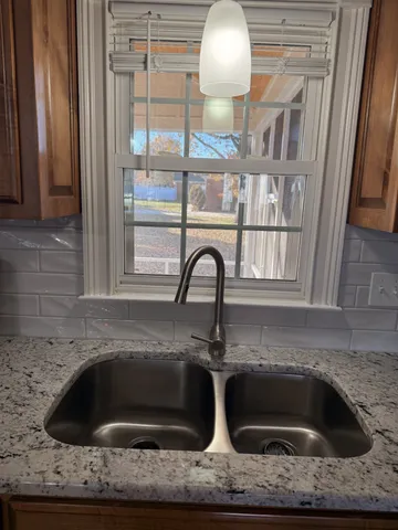 a kitchen with a sink and a window