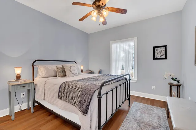 a bedroom with a bed and a chandelier