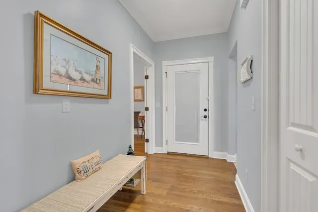 a view of room with hallway and wooden floor