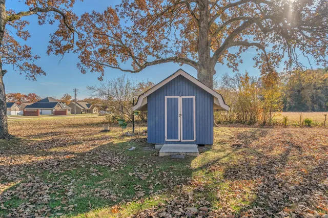 a view of a house with a yard and a tub