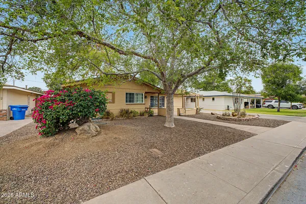 a view of a house with a yard and garage