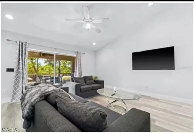 a living room with furniture and a flat screen tv