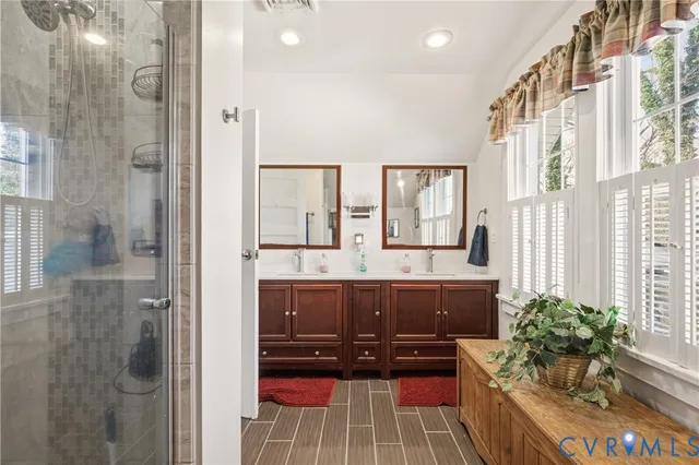 a bathroom with a tub shower and sink