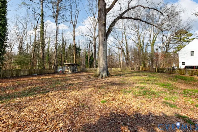 a view of a yard with a house and trees