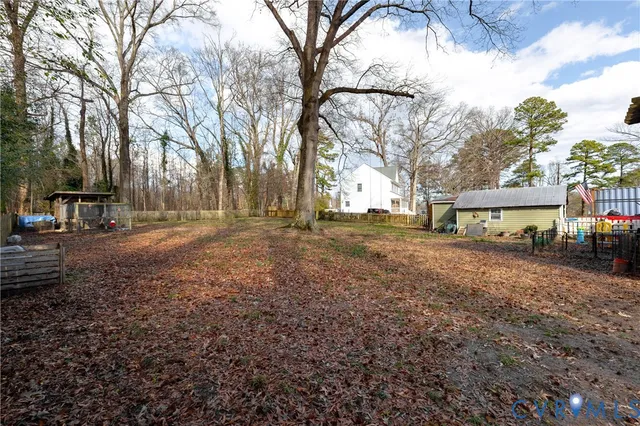 a view of a yard with a house and a trees