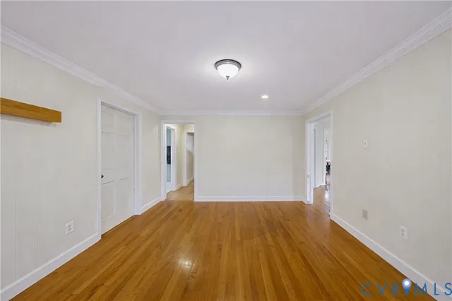a view of a room with wooden floor and brick walls