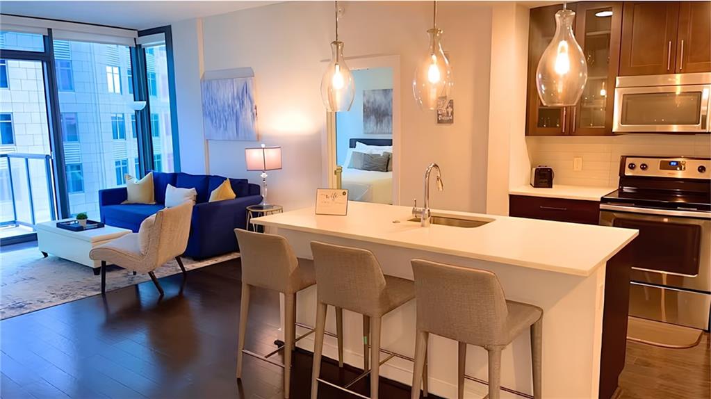 a kitchen with a table chairs and a refrigerator