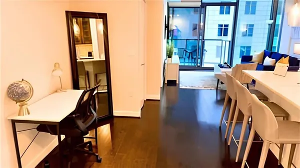 a view of a dining room with furniture and a floor to ceiling window