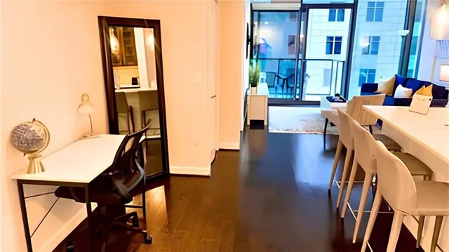 a view of a dining room with furniture and a floor to ceiling window