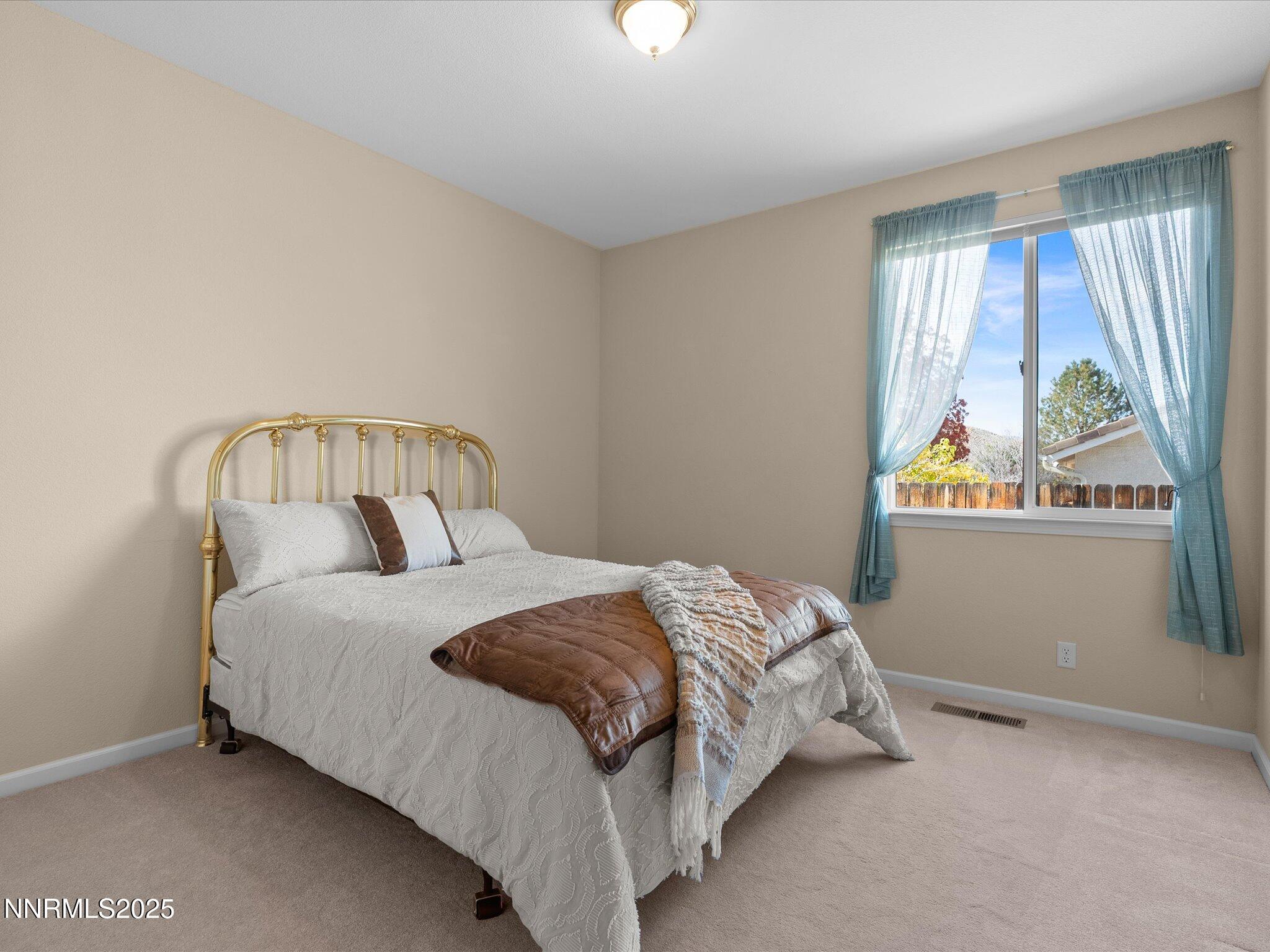 5952 Indus Drive Reno, NV 89502 - Photo 22 of 39 a bedroom with a bed and window
