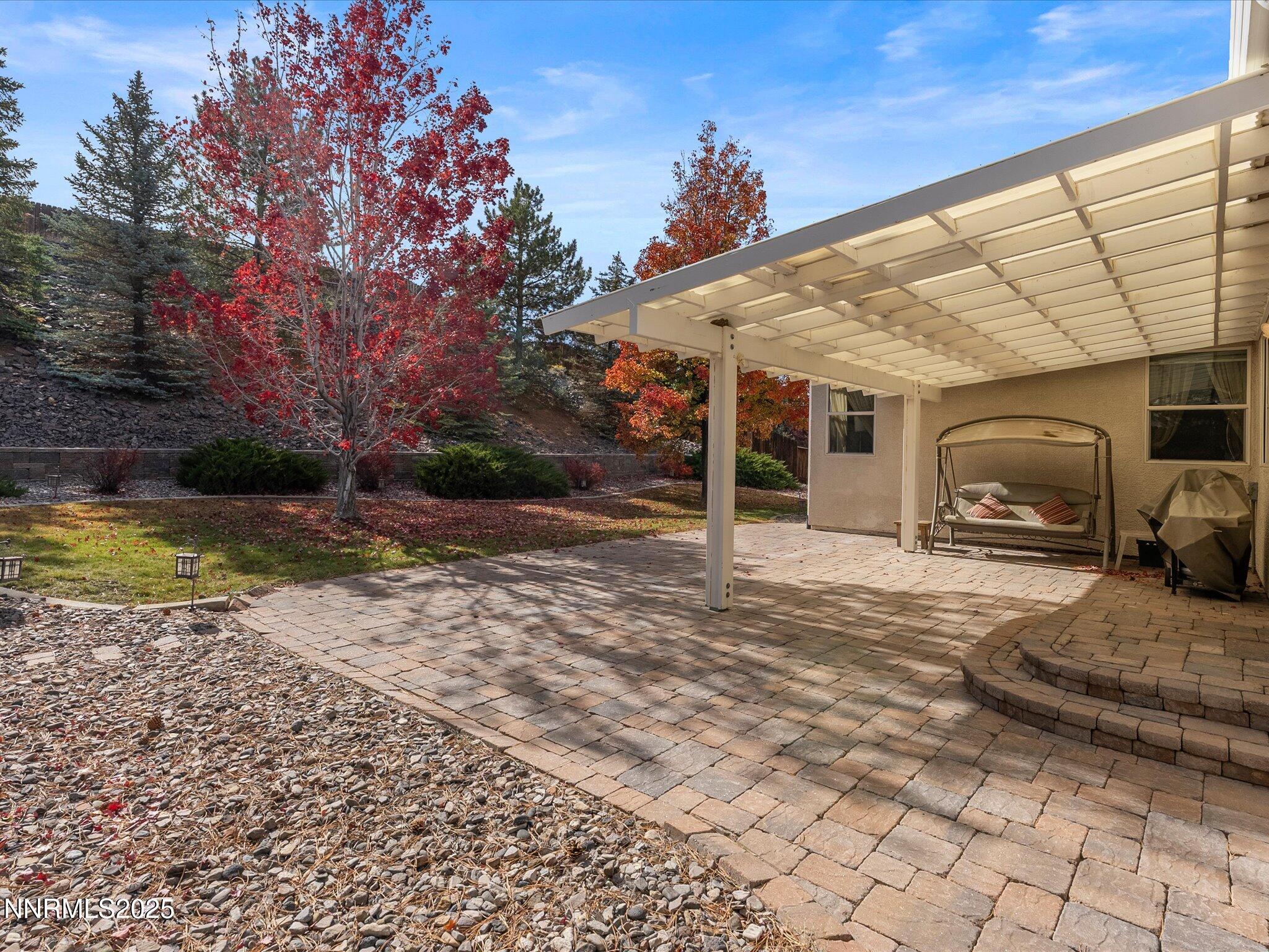 5952 Indus Drive Reno, NV 89502 - Photo 3 of 39 a front view of a house with a yard and garage