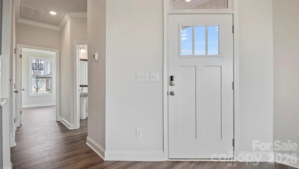 a view of a hallway with wooden floor
