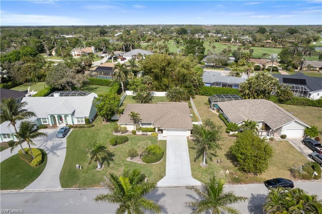 Undisclosed Address Naples, FL 34110 - Photo 2 of 19 an aerial view of a house with a garden
