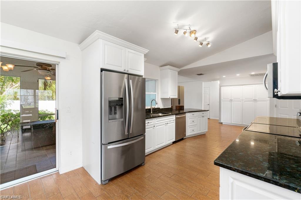 Undisclosed Address Naples, FL 34110 - Photo 4 of 19 a kitchen with stainless steel appliances granite countertop a refrigerator a stove and a sink