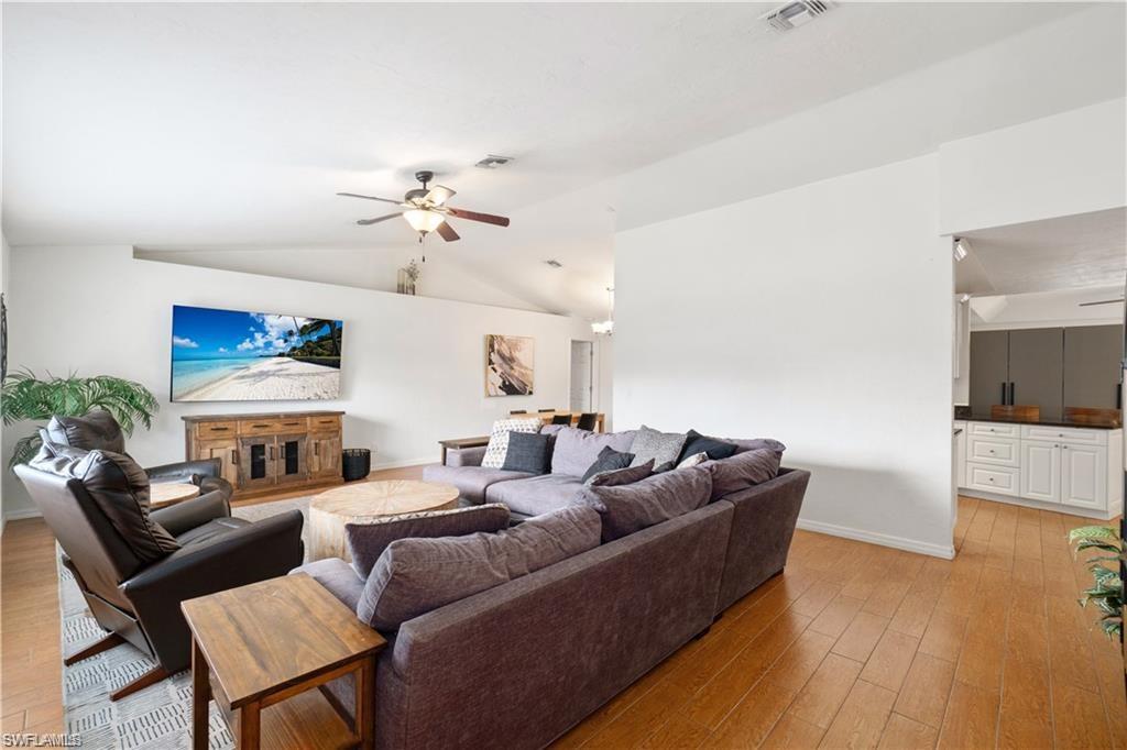 Undisclosed Address Naples, FL 34110 - Photo 8 of 19 a living room with furniture a flat screen tv and kitchen view