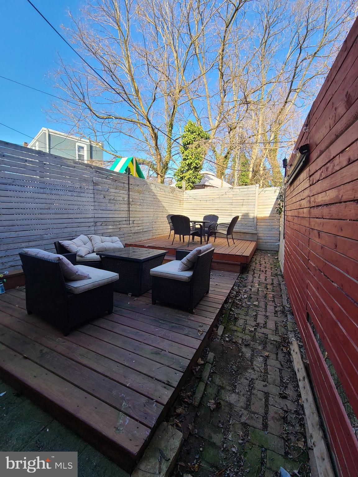 a view of a backyard with sitting area