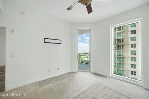 a view of a room with a ceiling fan and a window