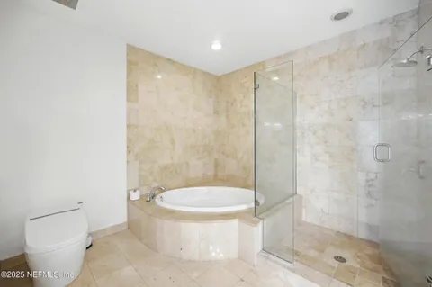 a view of balcony with a couple of cars parked in parking lot