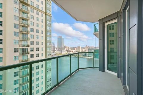 a living room with furniture and large windows
