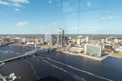 a room with pool table and two windows