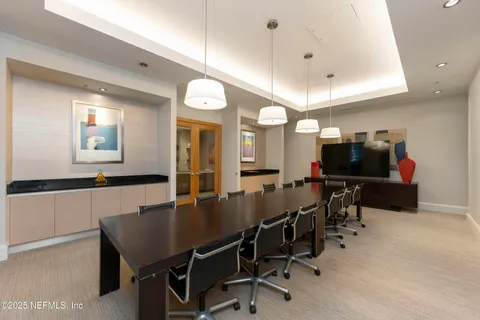 a room with furniture pool table and windows