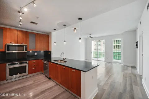 a kitchen with stainless steel appliances granite countertop a sink stove and refrigerator